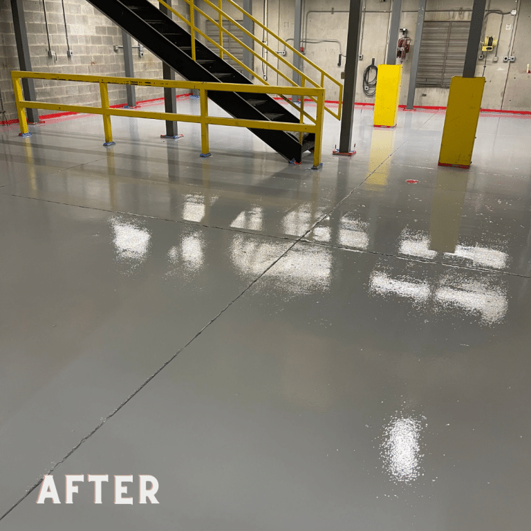 Image of a warehouse floor coated with a resinous epoxy flooring system. The floor has a smooth and glossy surface in shades of gray, with natural variations in color and texture.