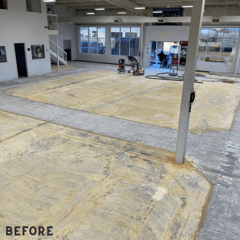 Image of a dull and uneven commercial concrete floor before grinding, with visible cracks and stains.